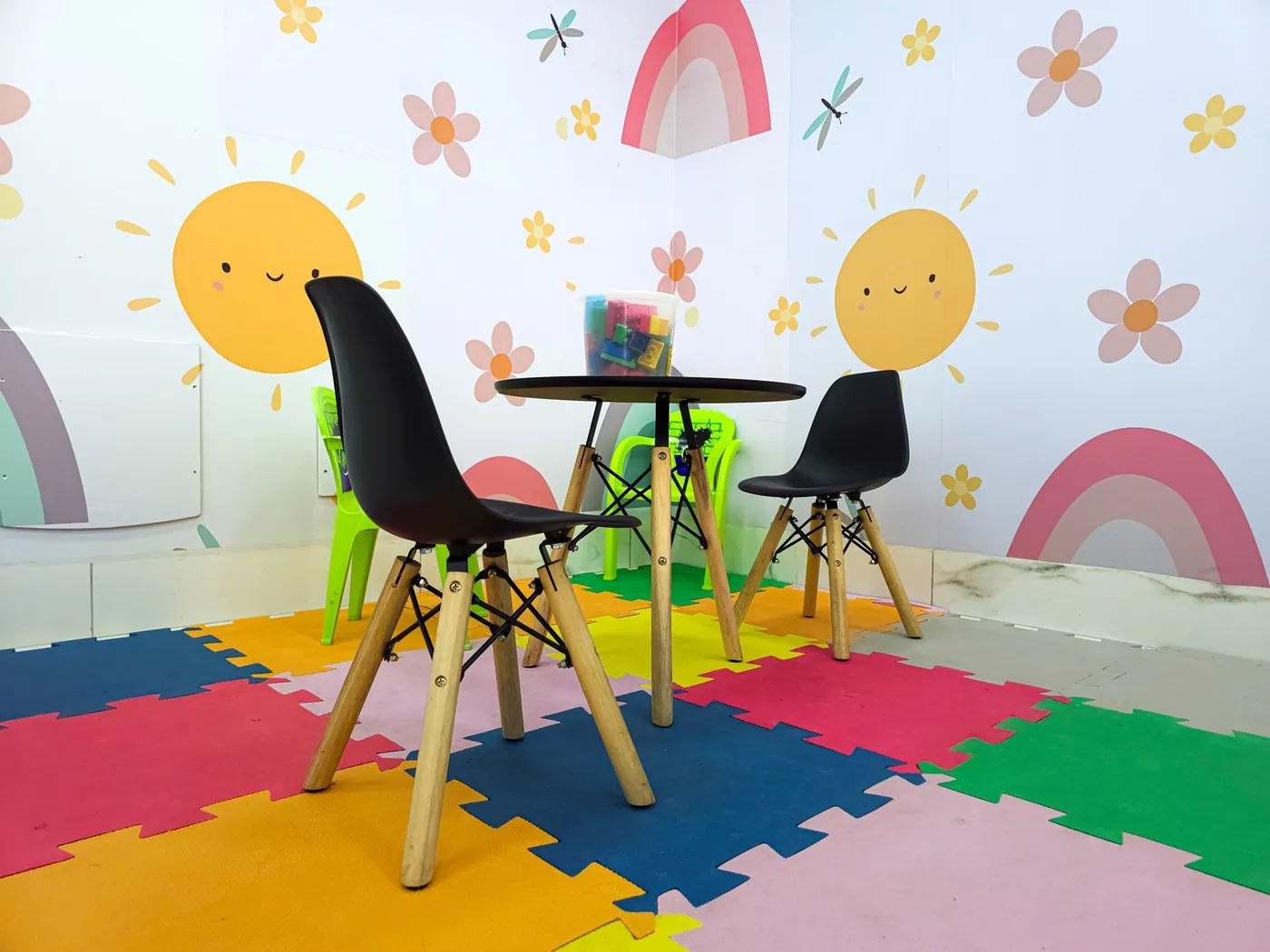 Sala infantil colorida com mesa, cadeiras e tapete de EVA